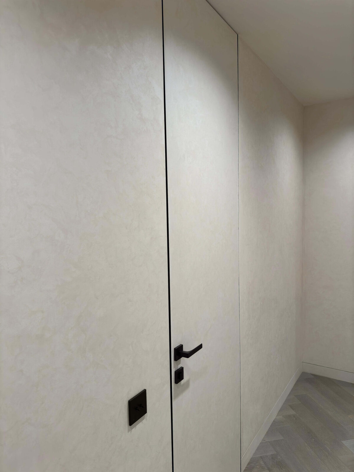 Декоративная штукатурка мокрый шелк Italica Luce в интерьере со скрытыми дверьми